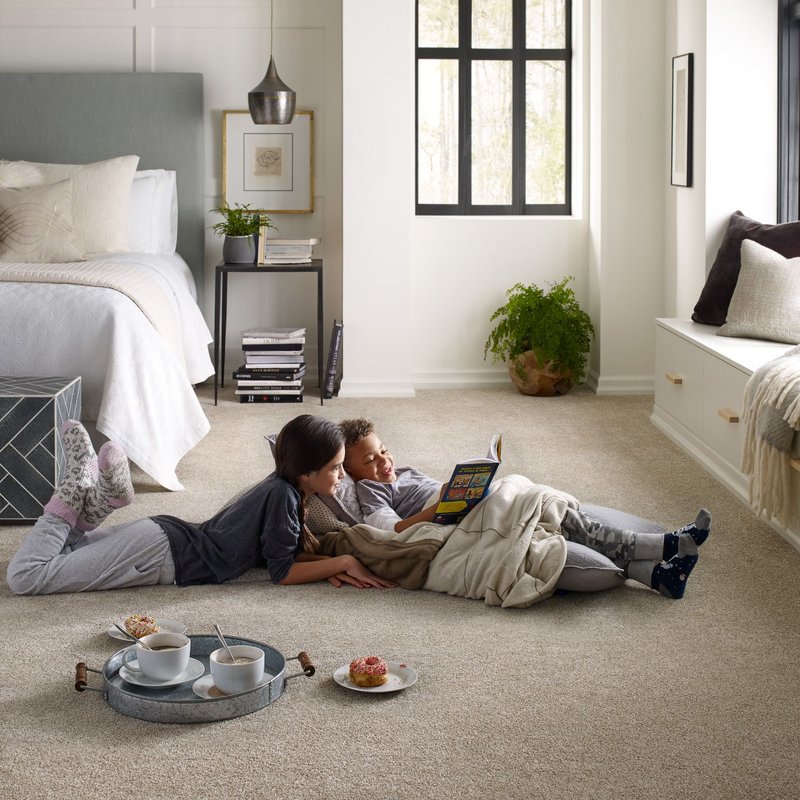 kids laying on carpet reading a book - Cut-Rite Carpets & Design Center in Scarsdale, NY