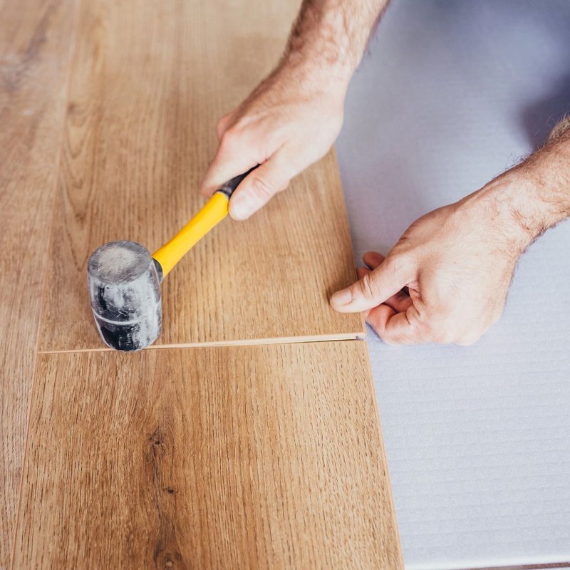 man installing hardwood flooring - Cut-Rite Carpets & Design Center in Scarsdale, NY